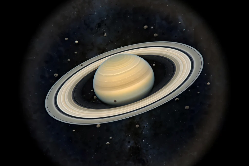 Saturn with its rings and many small moons in deep space